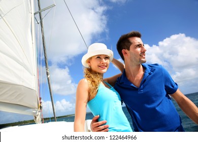 Smiling Rich Young Couple On A Sailboat In Caribbean Sea