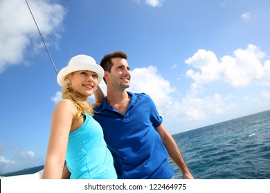 Smiling Rich Young Couple On A Sailboat In Caribbean Sea