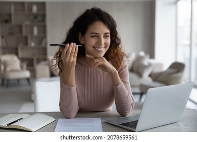 Smiling Satisfied Businesswoman Holding Smartphone, Listening To Voice Message In Social Network, Chatting Online By Speakerphone, Happy Young Woman Sitting At Desk With Laptop, Making Phone Call