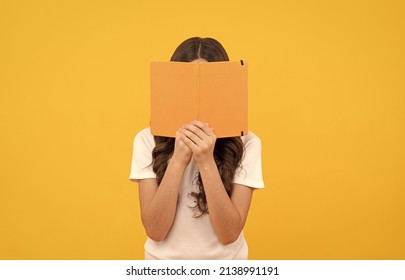 smiling school kid ready to study hide behind book, knowledge