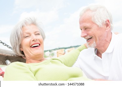 Smiling senior couple at the beach - Powered by Shutterstock