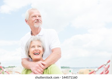 Smiling senior couple at the beach