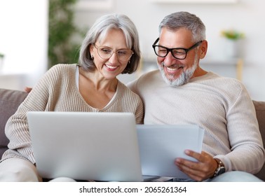 Smiling senior couple calculate expenses or planning budget together, reading notification letter with good news from bank, retired family husband and wife paying bills online on laptop - Powered by Shutterstock