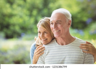 Smiling Senior Couple Embracing Outdoors