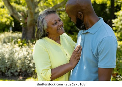 Smiling senior couple enjoying conversation and bonding in outdoor park. Friendship, retirement, elderly, leisure, happiness, companionship - Powered by Shutterstock