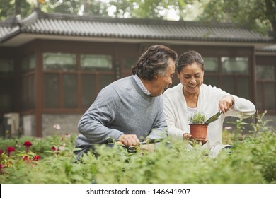 Smiling senior couple in garden - Powered by Shutterstock