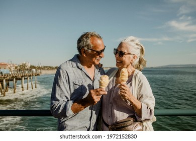 Smiling senior couple with an ice cream cone standing on the Santa Monica Pier - Powered by Shutterstock