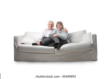 Smiling Senior Couple Sitting On A Couch