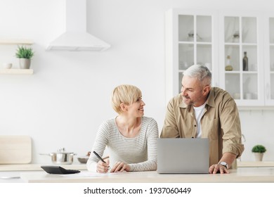 Smiling Senior Couple Spouses Use Laptop, Calculator, New Technology Paying Banking Bills Online