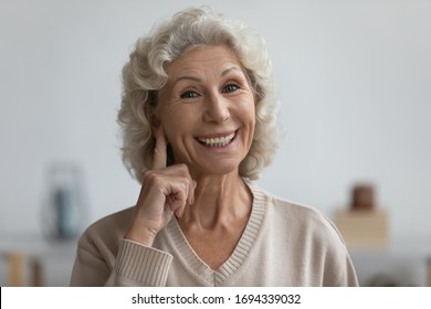 Smiling Senior Elderly Woman Looking At Camera, Showing On Ear, Having Trouble With Hearing, Asking Speaking Louder. Head Shot Close Up Portrait Happy Middle Aged Grandmother With Health Disability.