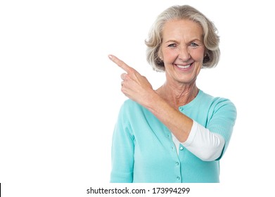 Smiling Senior Lady Pointing Towards Something