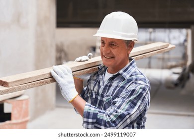 Smiling senior male carpenter with planks on shoulder - Powered by Shutterstock