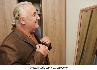 Smiling Senior Man Happy With His Outfit Looking At Mirror Before Leaving House