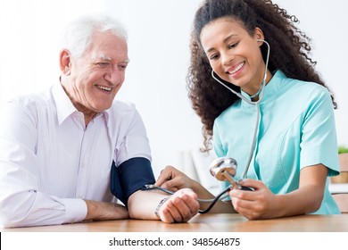 Smiling Senior Man Having Measured Blood Pressure