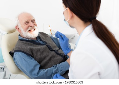 Smiling Senior Man Having Teeth Treatment By Dentist In Latex Gloves In Dental Clinic