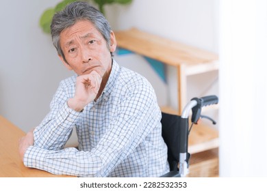 Smiling senior man in wheelchair - Shutterstock ID 2282532353