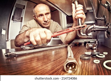 Smiling Senior Plumber At Work