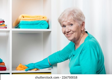 Smiling Senior Woman Cleaning House Before Christmas