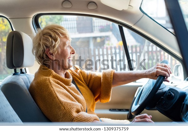 Smiling senior woman driving a
car