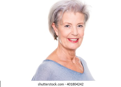 Smiling senior woman in front of white background