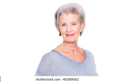 Smiling senior woman in front of white background