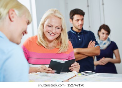 Smiling senior woman making appointment at doctors office at the reception - Shutterstock ID 152749190
