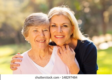 Smiling Senior Woman And Middle Aged Daughter Outdoors Closeup Portrait