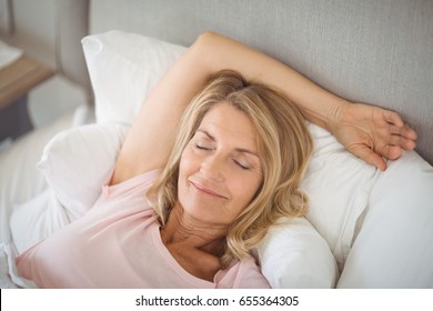 Smiling Senior Woman Relaxing In Bed