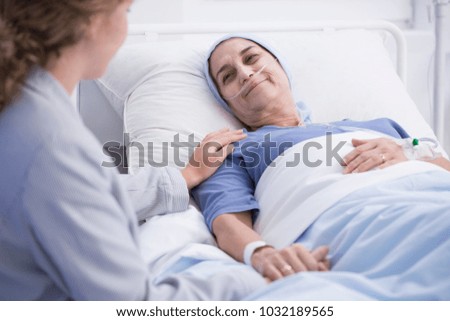 Smiling senior woman with a tumor and caring nurse in the health center Stockfoto © 