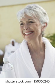 Smiling Senior Woman Wearing Bathrobe In Dayspa