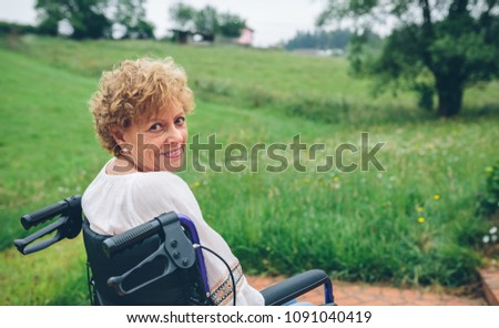 Smiling senior woman in wheelchair