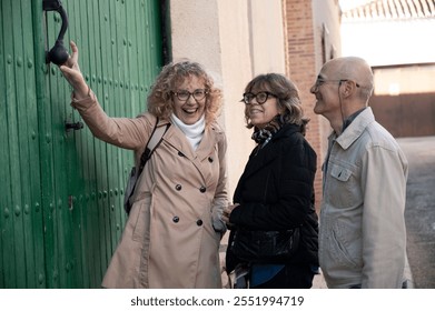 Smiling seniors share a moment of humor and laughter by a traditional green door - Powered by Shutterstock