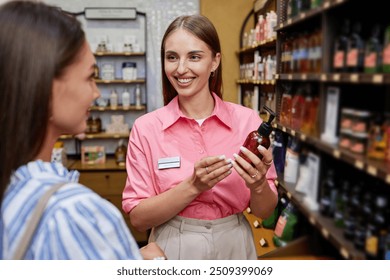 Smiling shop assistant recommending new cleanser to customer - Powered by Shutterstock