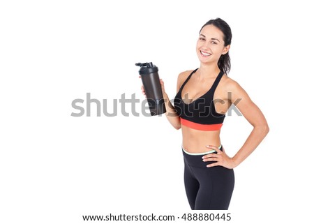 Smiling slim girl in sportswear holding a large water bottle. Concept of sufficient hydration is the right way to weight loss. Mockup
