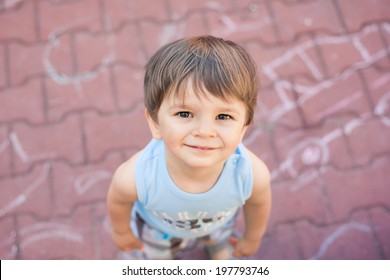 Smiling Small Boy Looking Up At Camera