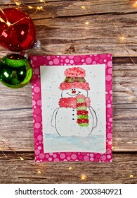 Smiling snowman painted on a card