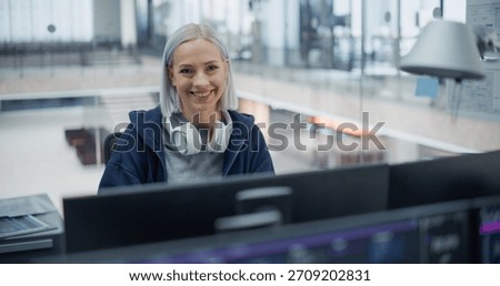 Smiling Software Engineer With Headphones, Working on Ai Development in a Modern Office. Highlights Innovation, Technical Skill, and Focus in Programming and Artificial Intelligence Solutions.