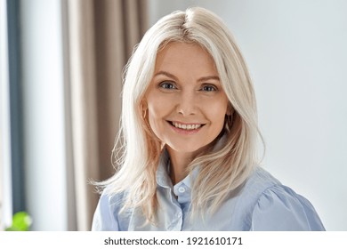 Smiling Sophisticated 50s Middle Aged Blond Business Woman Looking At Camera. Happy Mature Elegant Old Lady Professional Businesswoman Posing At Home Office. Headshot Close Up Portrait