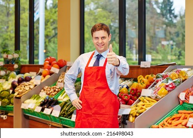 Smiling Store Manager In A Supermarket Holding His Thumbs Up