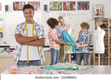 Smiling Student Sewing Clothing In Home Economics Classroom