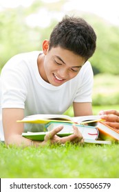 Smiling Student Studying Outdoors With Books