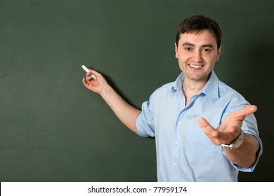 Smiling Student Or Teacher At The Blackboard