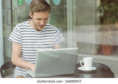 Smiling Student Using Laptop In Cafe At The University