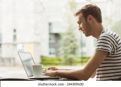 Smiling Student Using Laptop In Cafe At The University