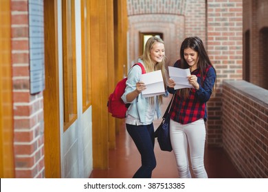 Smiling Students Looking At Results At University