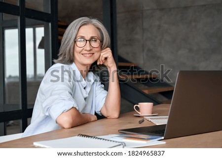 Similar – Image, Stock Photo senior woman working in atelier shop with rolls of fabrics. Cutting fabrics. Small business