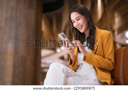 smiling successful attractive asia female woman exited promotion news offer from her message on smartphone,shopping online application technology device ,promotion news offer greeting seasonal
