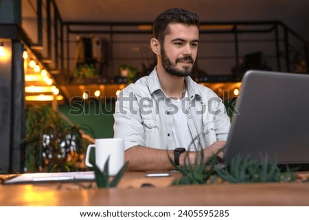 Smiling successful caucasian young businessman freelancer student it-specialist professional manager working on laptop on new startup project, e-learning remotely in office