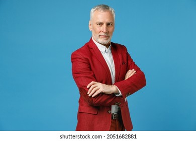 Smiling Successful Confident Elderly Gray-haired Mustache Bearded Business Man Wearing Red Jacket Suit Standing Holding Hands Crossed Looking Camera Isolated On Blue Color Background Studio Portrait