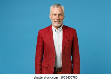 Smiling Successful Handsome Attractive Elderly Gray-haired Mustache Bearded Business Man Wearing Red Jacket Suit Standing And Looking Camera Isolated On Blue Color Wall Background Studio Portrait